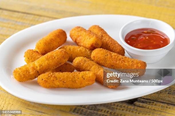 close-up of fried food in plate on table,romania - cheese stick stock-fotos und bilder