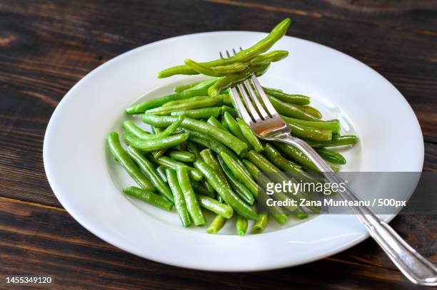 close-up of green peas in plate on table,romania - green beans stock pictures, royalty-free photos & images