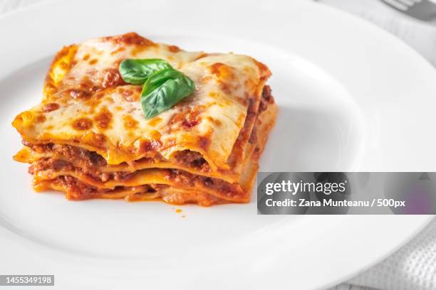 close-up of pizza in plate on table,romania - serving lasagna stock pictures, royalty-free photos & images