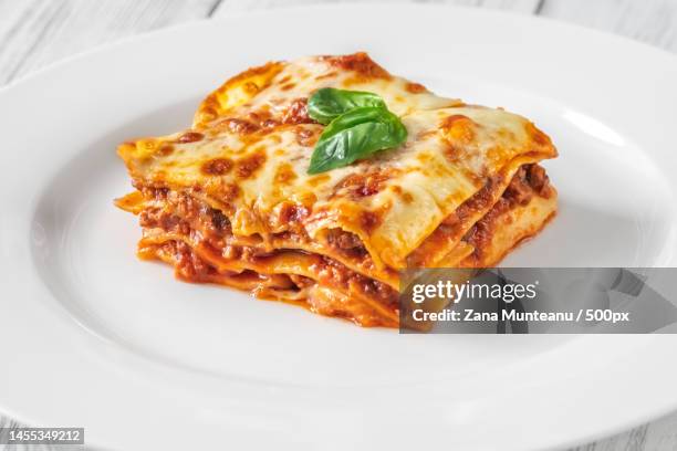 close-up of pizza in plate on table,romania - lasagna stockfoto's en -beelden