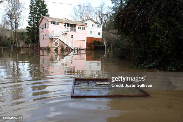 Section of fence floats in a flooded neighborhood on January 09, 2023 in Guerneville, California. The San Francisco Bay Area continues to get...