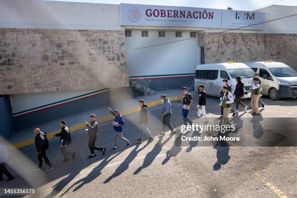 Immigrants, most from Venezuela, are escorted by Mexican immigration agents after being expelled from the United States on January 09, 2023 in Ciudad...