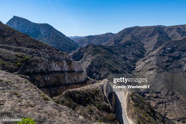oman, dhofar, road in rugged mountains - dhofar stock pictures, royalty-free photos & images