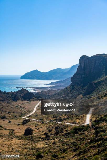 oman, dhofar, salalah, winding road with coastal cliffs in background - salalah stock pictures, royalty-free photos & images