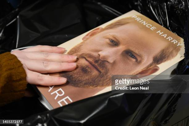 Copies of "Spare" by Prince Harry are unwrapped from protective packaging as they go on sale at one minutes after midnight in WH Smith bookstore at...