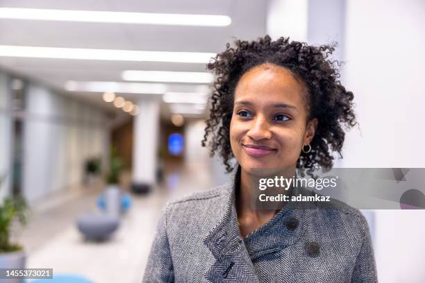 portrait of a young black businesswoman - sideways glance stock pictures, royalty-free photos & images