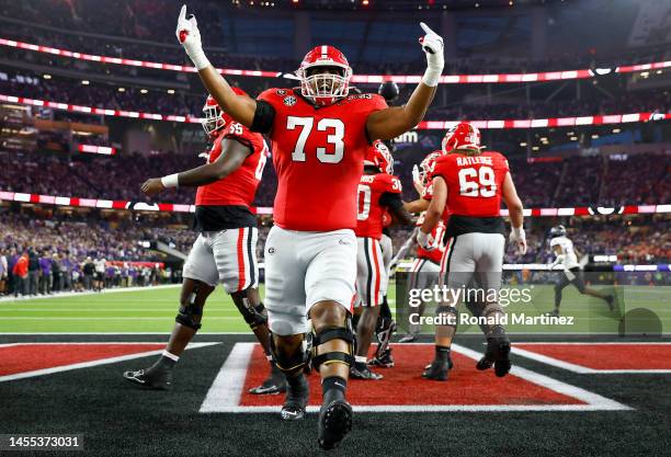 Xavier Truss of the Georgia Bulldogs celebrates with teammates after a touchdown in the first quarter against the TCU Horned Frogs in the College...