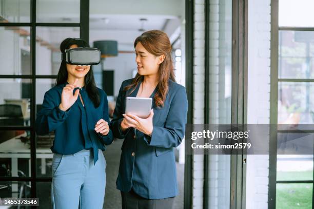 excited asian testers wearing vr glasses at office - vr goggles business stockfoto's en -beelden