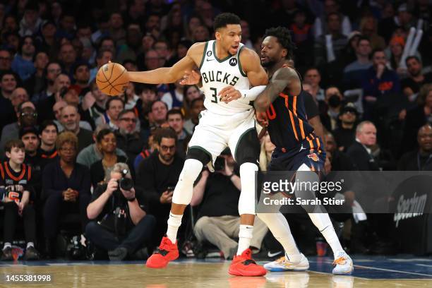 Giannis Antetokounmpo of the Milwaukee Bucks dribbles against Julius Randle of the New York Knicks during the first half at Madison Square Garden on...
