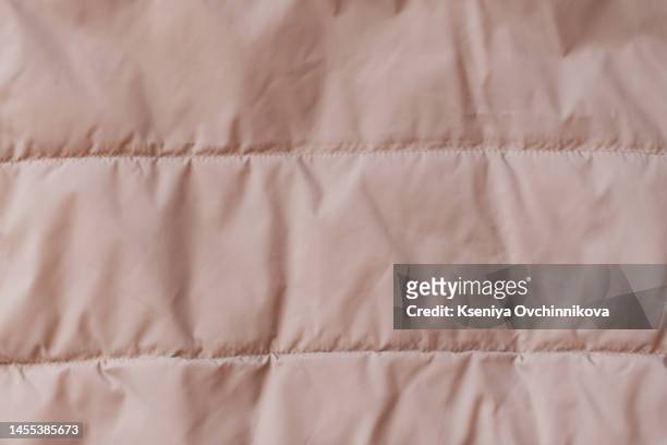 quilted fabric background. beige texture blanket or puffer jacket - down feather stock pictures, royalty-free photos & images