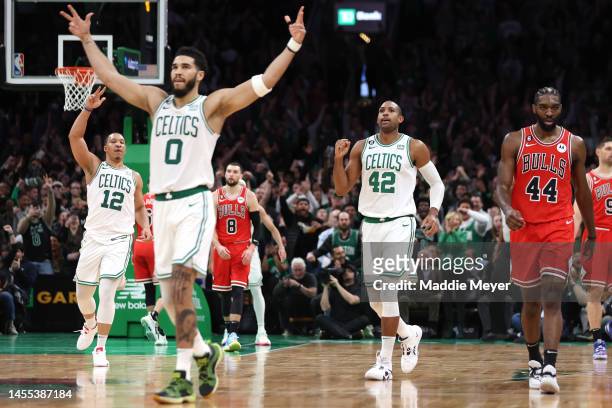 Al Horford of the Boston Celtics celebrates with Jayson Tatum and Grant Williams after scoring against the Chicago Bulls during the second half at TD...