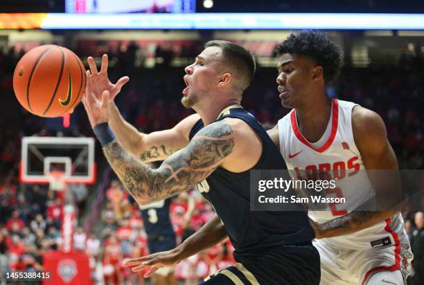 Carlos Jürgens of the Oral Roberts Golden Eagles loses the ball as Donovan Dent of the New Mexico Lobos defends during the first half of their game...