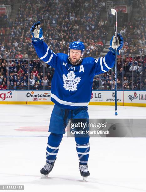 Morgan Rielly of the Toronto Maple Leafs celebrates a goal by teammate Pontus Holmberg against the Detroit Red Wings during the third period at the...