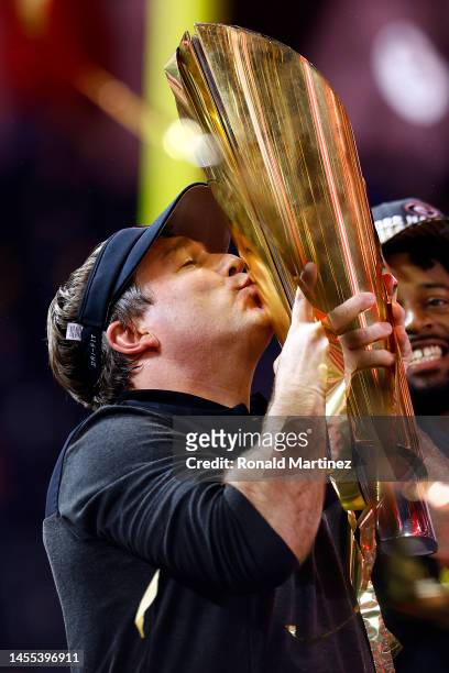 Head coach Kirby Smart of the Georgia Bulldogs kisses the National Championship trophy in the College Football Playoff National Championship game at...