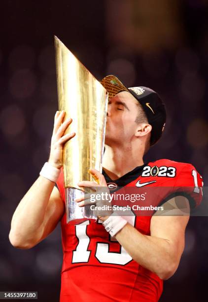 Stetson Bennett of the Georgia Bulldogs kisses the College Football Playoff National Championship Trophy after defeating the TCU Horned Frogs in the...