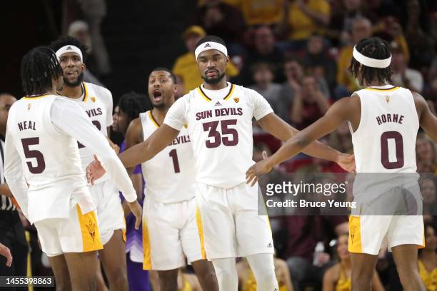 Devan Cambridge of the Arizona State Sun Devils celebrates with teammates after a big slam dunk during the second half of the game between the...