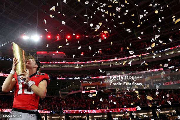 Stetson Bennett of the Georgia Bulldogs celebrates with the College Football Playoff National Championship Trophy after defeating the TCU Horned...
