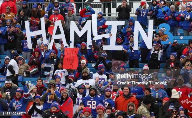 Buffalo Bills fans hold signs in support of Buffalo Bills safety Damar Hamlin prior to the game between the Buffalo Bills and the New England...