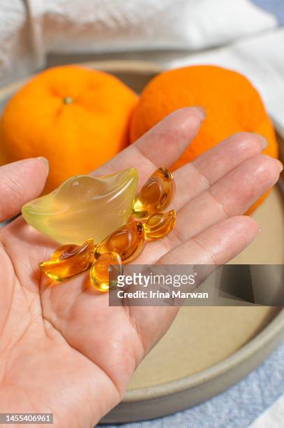 chinese new year ornament and tangerines - yuanbao stock pictures, royalty-free photos & images