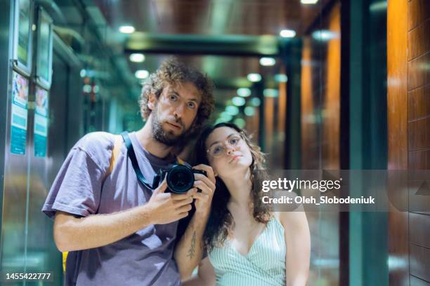 selfie of man and woman in elevator mirror - elevetor photo stock pictures, royalty-free photos & images