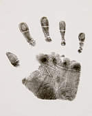 Human palm print on white paper with ink