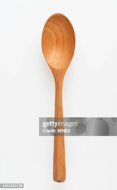 directly above view of wooden spoon against white background - utensile di portata foto e immagini stock