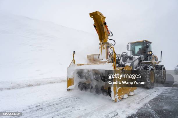a snowplow on the highway is removing snow - snowplough stock pictures, royalty-free photos & images