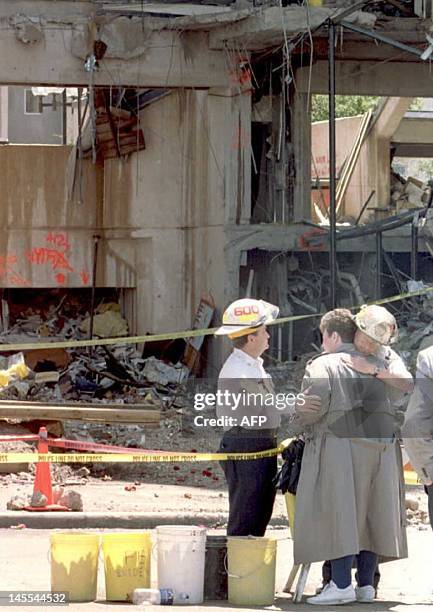 Relatives of victims of the 19 April Alfred P. Murrah building car bombing hug an Oklahoma City Fire Department rescue crew member during a memorial...