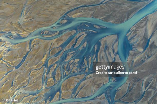 aerial abstract view taken by drone of icelandic glacier river during an autumn day, iceland, europe - nun river estuary stock-fotos und bilder