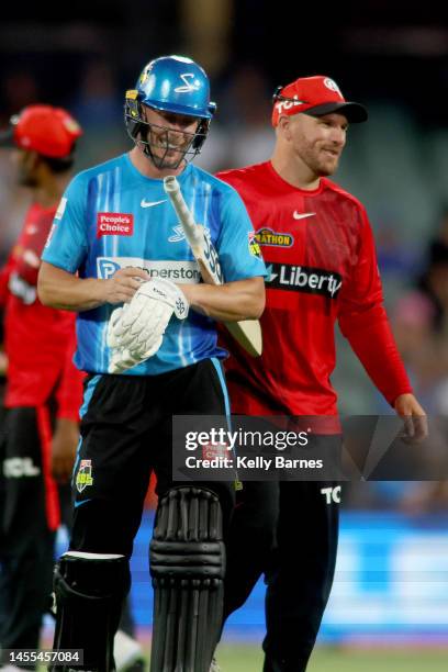 Chris Lynn of the Strikers and Aaron Finch captain of the Renegades chat at the end of the innings during the Men's Big Bash League match between the...