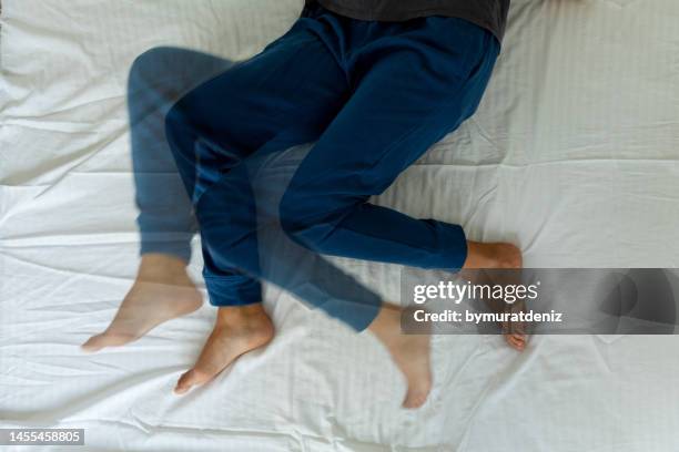 young woman on the bed - woman foot massage stock pictures, royalty-free photos & images