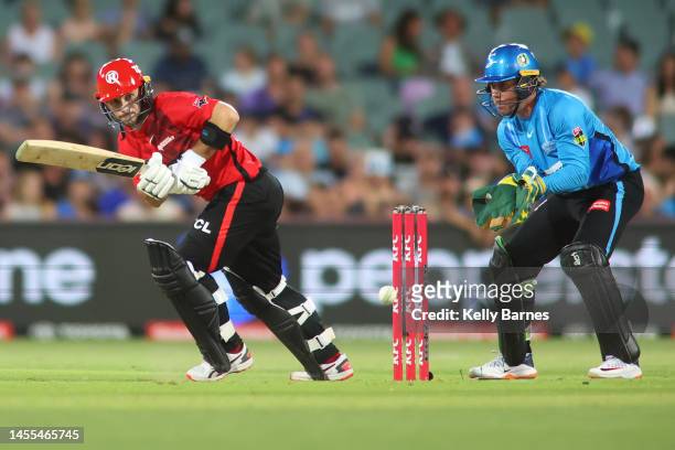 Jonathan Wells of the Renegades batting the ball away from Harry Nielsen of the Strikers during the Men's Big Bash League match between the Adelaide...