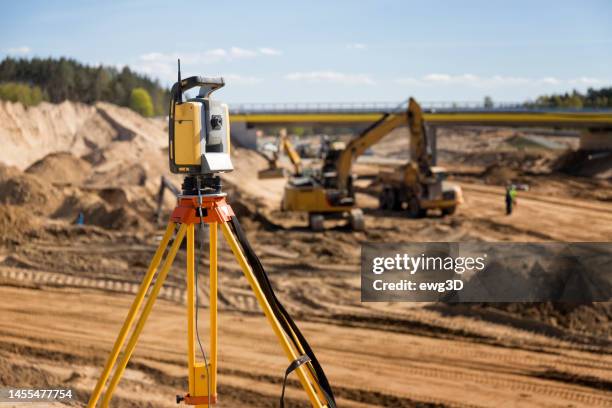 landsurveyor equipment on a highway construction site - geodesy stock pictures, royalty-free photos & images