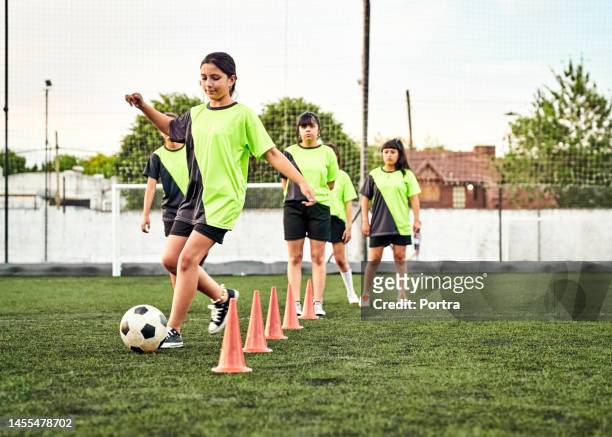 girls soccer players training on playground - coordinated effort stock pictures, royalty-free photos & images