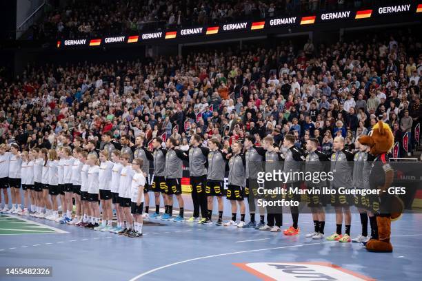 The German team stands together while singing the national anthem during the handball international friendly match between Germany and Iceland at...