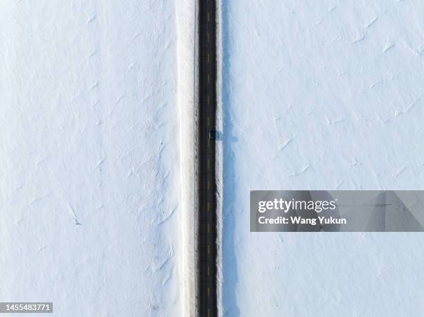 there is a highway in the vast snowfield - linear image stock pictures, royalty-free photos & images