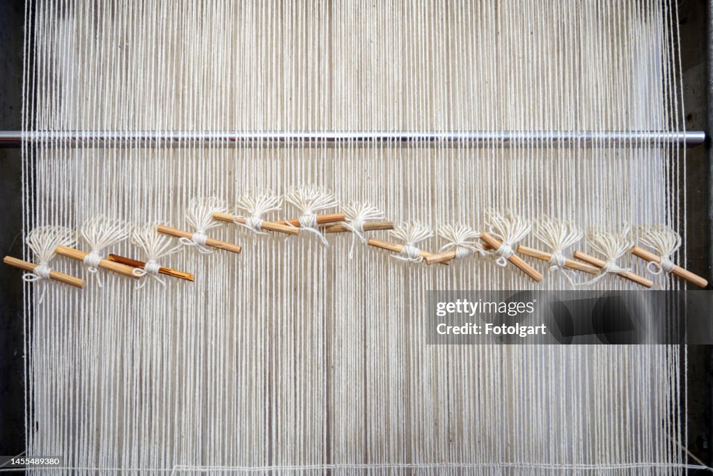 Wool threads prepared and lined up on a weaving loom