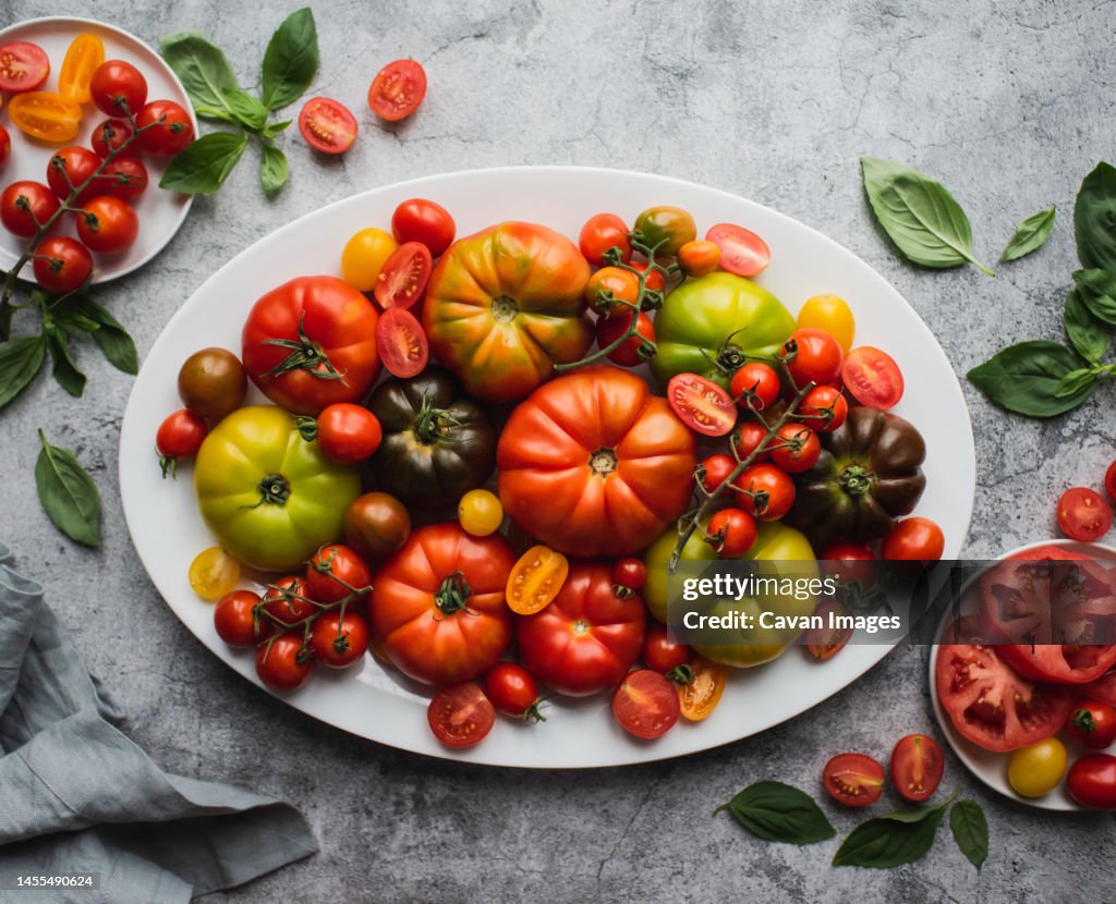 Top view of platter of colorful heirloom and cherry tomatoes