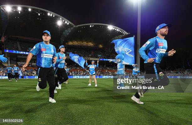 Strikers head out to field during the Men's Big Bash League match between the Adelaide Strikers and the Melbourne Renegades at Adelaide Oval, on...