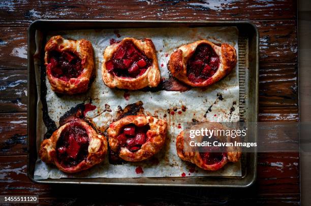 rustic rhubarb pastries on baking tray - arlington virginia stock pictures, royalty-free photos & images