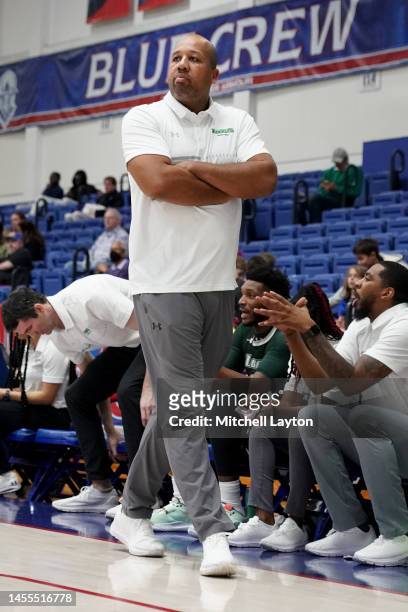 Head coach Travis Hardy of the Loyola Greyhounds looks on during a college basketball game against the American University Eagles at Bender Arena on...