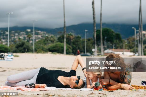 a family having fun on a sunny beach in anaheim california, usa - anaheim - california ストックフォトと画像