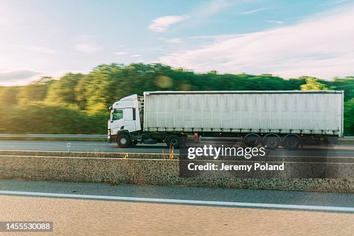 Driver's Point of View of a Cabover Style Semi Truck Driving on the a13 Autoroute in Northern France near Caen in the Summer on a Sunny Day