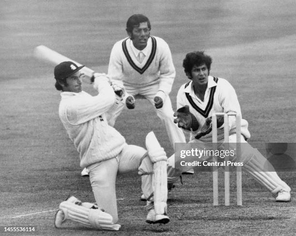 Zaheer Abbas and wicketkeeper Wasim Bari of the touring Pakistan Cricket Team look on from behind the stumps as England batsman Alan Knott plays a...