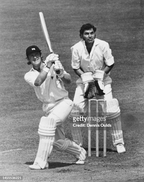 Wicketkeeper Farokh Engineer of India looks on from behind the stumps as batsman Dennis Amiss of England plays an on drive shot off a delivery by...
