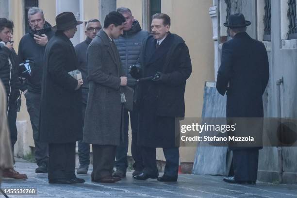 British director and actor Kenneth Branagh, as Poirot, talks with other actors during the filming of "A Haunting in Venice" on January 10, 2023 in...