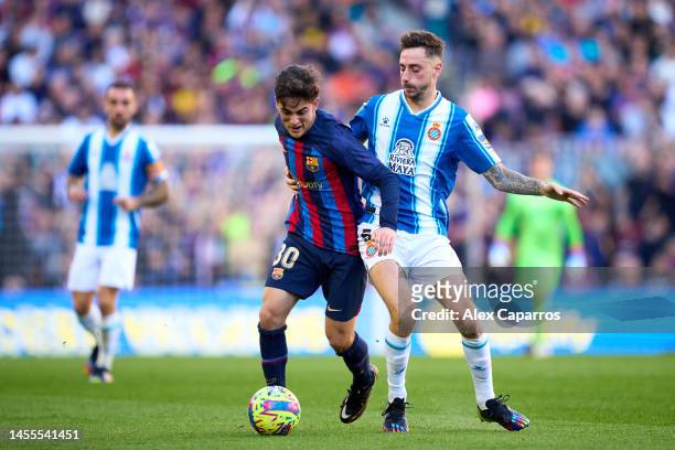 Pablo Paez 'Gavi' of FC Barcelona is challenged by Fernando Calero of RCD Espanyol during the LaLiga Santander match between FC Barcelona and RCD...