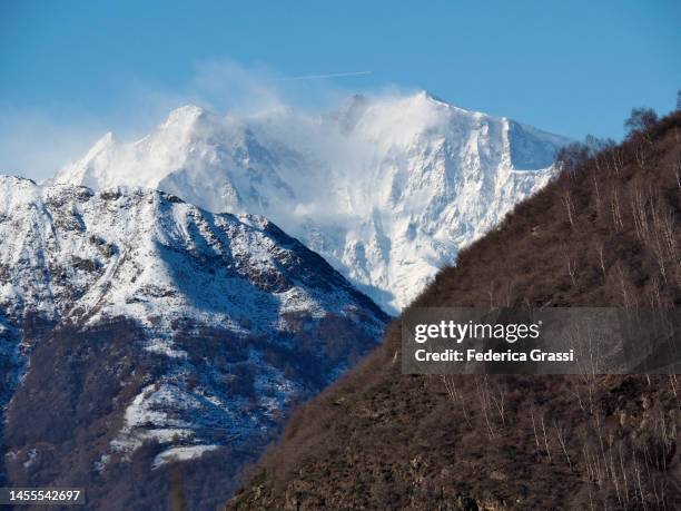 view of monte rosa with snow lifted by the wind, seen from alpe la colla, val grande national park - monte rosa fotografías e imágenes de stock