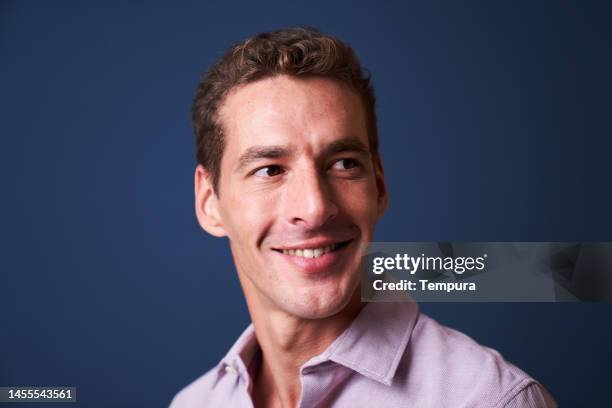 portrait of content handsome mid adult businessman with a seductive smile and a twinkle in his eye - male looking content stock pictures, royalty-free photos & images