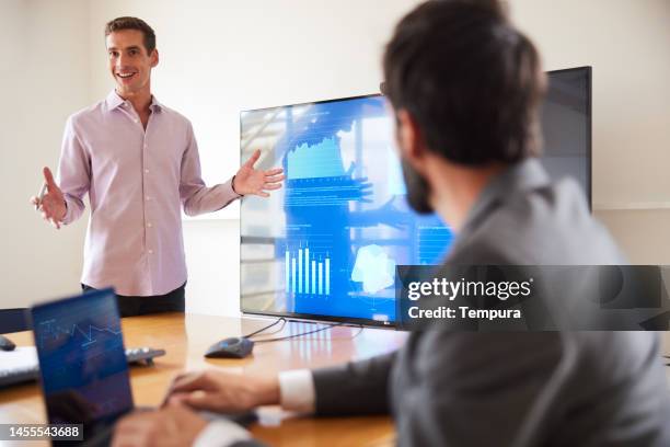 confident good-looking male presenter responds to questions during a business meeting - presentation of paulinho as new player of the pc barcelona stockfoto's en -beelden